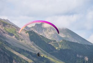 Experience thrilling paragliding over stunning mountain landscapes, perfect for adventure seekers.